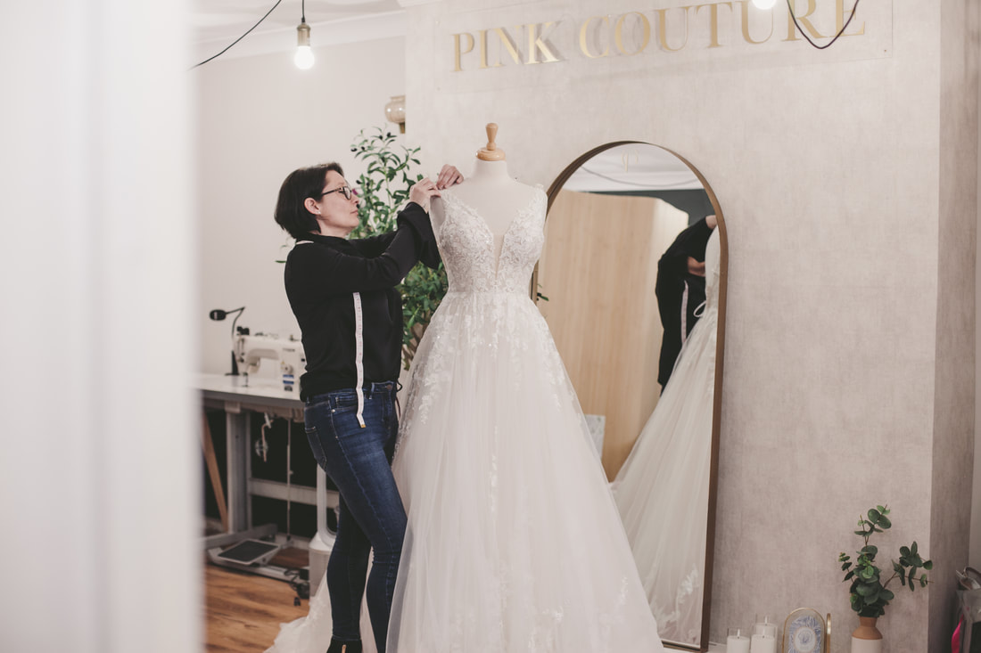 Gemma adjusting a wedding dress for a clients collection from the bridal studio near Norwich, Norfolk